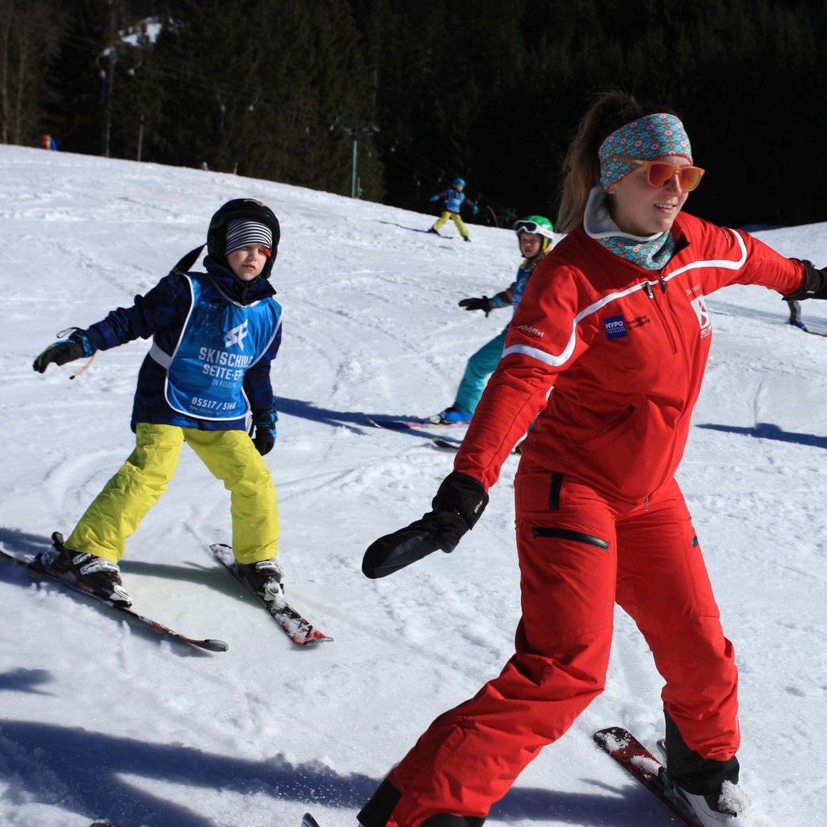 Ski instructor teaching children to ski on a snowy slope. © Skischule Seite Egg